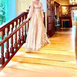 Elegant A line blush colored floor length ball gown with chiffon back detailing